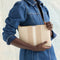 hover | Model shown holding the Convertible Clutch in Oat Latte.