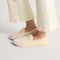 hover | Model wearing The Teddy Slipper in Oat Milk.