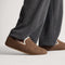 hover | Model wearing The Teddy Men's Slipper in Cocoa Spice.