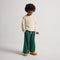 model | Alternate view of a child wearing The Teddy Kids Slipper in Wren.