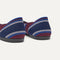 Close up of the heel of The Daily Flat in Fig Stripe, with Rothy's signature blue halo. 