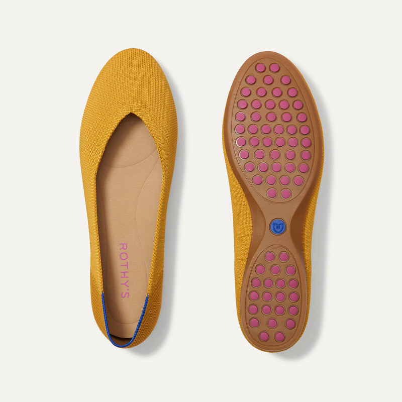PLP |The Daily Flat in Marigold shown from the top with one shoe showing the outsole. 