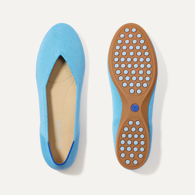 PLP |The Daily Flat in Robin Blue shown from the top with one shoe showing the outsole. 
