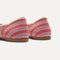 Close up of the heel of The Daily Flat in Sunkiss Stripe, with Rothy's signature blue halo. 
