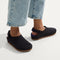hover | A child wearing The Kids Clog in Black. 