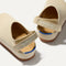 Close up of the heel of The Kids Clog in Conch, with Rothy's signature blue halo. 