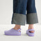hover | A child wearing The Kids Clog in Soft Orchid. 