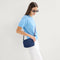 hover | The Crossbody Camera Bag in  Lagoon Open-Knit worn as a crossbody by a model.