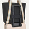 The Travel Tote in Ink, shown attached to a rolling suitcase using the wrap-around band.
