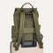 The Travel Cinch Backpack in Forest shown from the back, shown attached to a rolling suitcase using the wrap-around band.