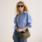 hover |Model carrying The Travel Sling in Forest shown from the front.