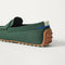 Close up of the heel of The Men's Driver in Dark Green, with raised peg outsoles and Rothy's signature blue halo. 