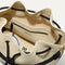 A close up of The Cinch Bucket Bag in Black and White Raffia-Knit showing the interior pockets.