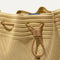 A close up of The Cinch Bucket Bag in Brown Butter Crochet showing the drawstring closure.