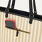 A closeup of The Two-Way Tote in Sandbar, focusing on the exterior zip pocket.