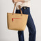 hover | Model carrying The Two-Way Tote in Sienna.