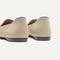Close up of the heel of The Daily Loafer in Ecru, with raised peg outsoles and Rothy's signature blue halo. 