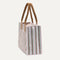 The Classic Tote in Watermelon Market Stripe, shown from the side.