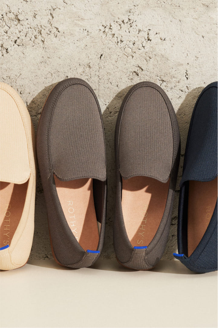 A row of The Ravello Loafer in various colors propped up against a wall.
