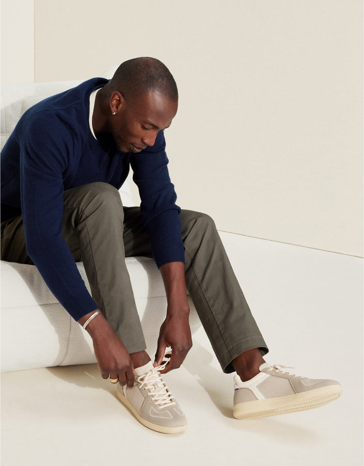 A male model wearing The RS01 Sneaker in Palm Grey.