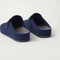 Close up of the heel of The Men's Clog in ReVelvet™ Deep Navy, with Rothy's signature blue halo. 