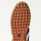 Close up of the durable rubber outsoles of The Ivy Sneaker in ReVelvet Black.
