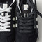 Overlay:: Extra pair of laces included—swap for a new look anytime. | Alt:: Close up of the top of The Ivy Sneaker in ReVelvet Black, showing different lace choices.