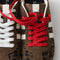 Overlay:: Extra pair of laces included—swap for a new look anytime. | Alt:: Close up of the top of The Ivy Sneaker in ReVelvet Cheetah, showing different lace choices.