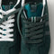 Overlay:: Extra pair of laces included—swap for a new look anytime. | Alt:: Close up of the top of The Ivy Sneaker in ReVelvet Evergreen, showing different lace choices.