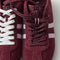 Overlay:: Extra pair of laces included—swap for a new look anytime. | Alt:: Close up of the top of The Ivy Sneaker in ReVelvet Syrah, showing different lace choices.