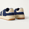 Close up of the heel of The Men's Court Sneaker in ReVelvet™ Deep Navy, with Rothy's signature blue halo.