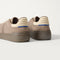 Close up of the heel of The Men's Court Sneaker in ReVelvet™ Sparrow, with Rothy's signature blue halo.