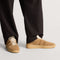 hover | Model wearing The Men's Court Sneaker in ReVelvet™ Pecan.