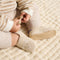 model | Model wearing The Baby Moc in Frosted Teddy.