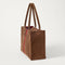 The Classic Tote in ReVelvet Cinnamon Stripe, shown from the side.