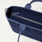 A close up of The Lightweight Zip Tote in ReVelvet Deep Navy focusing on the zip closure and handles.