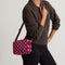 hover | Model wearing The Crossbody Camera Bag in  ReVelvet™  Orchid, shown from the front. 