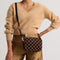hover | Model wearing The Crossbody Camera Bag in  ReVelvet™ Umber Check, shown from the front. 