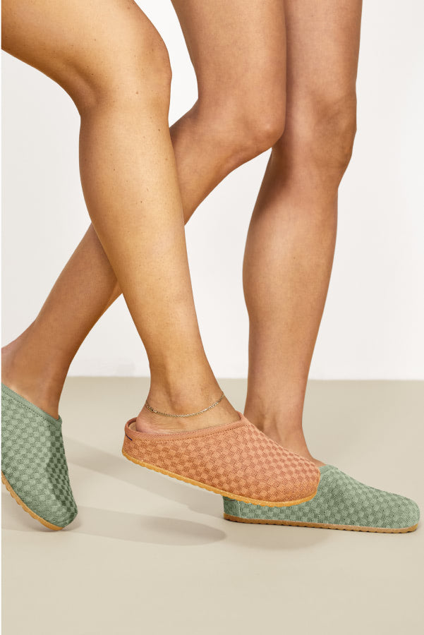 A female model wearing The Casual Clog in Clay and Sage