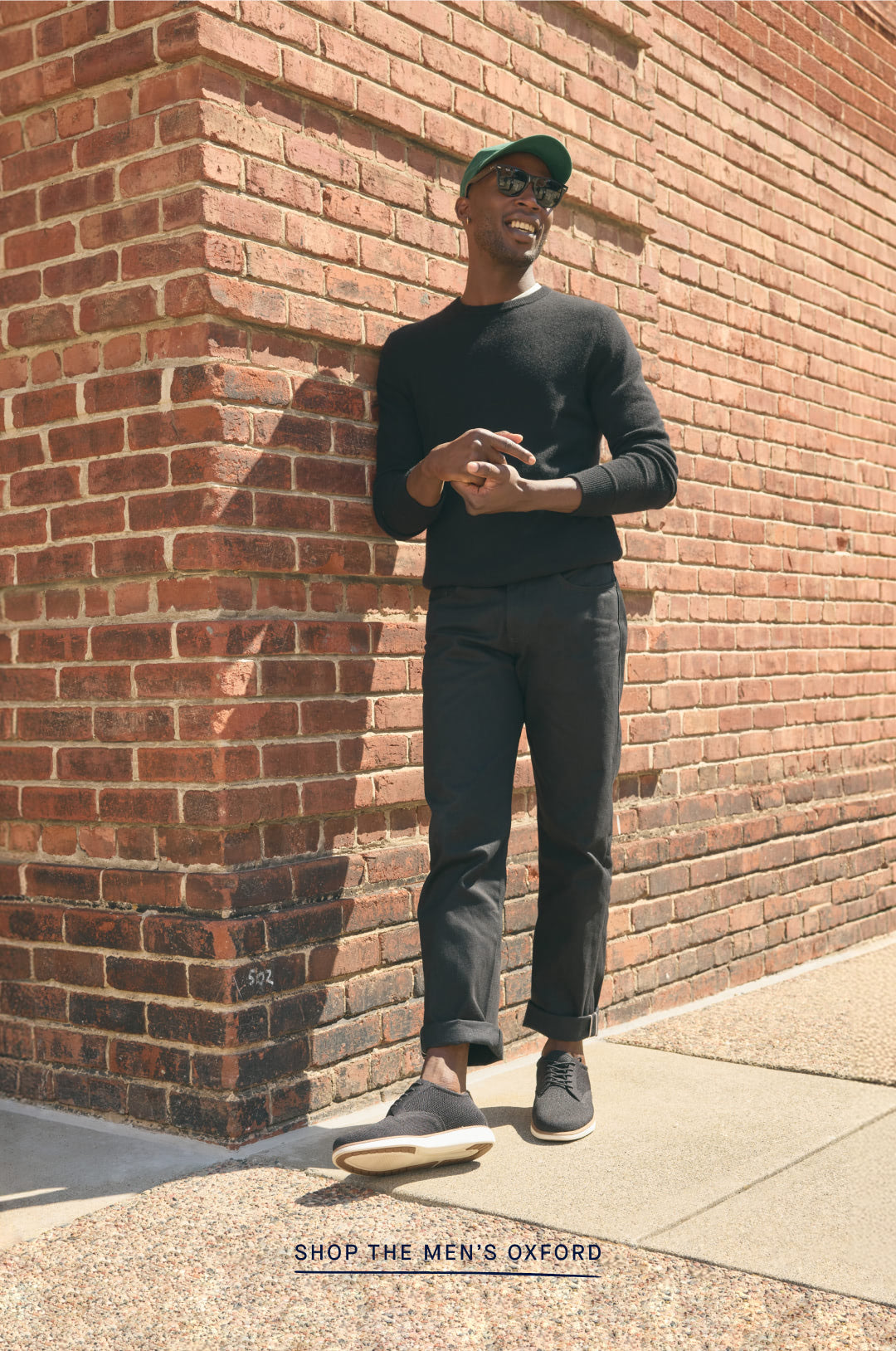 A model wearing The Oxford in Black, with copy overlay reading "SHOP THE MEN'S OXFORD"