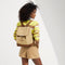 hover | Model wearing The Cinch Backpack in Brown Butter on her back.