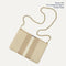 The Convertible Clutch in Oat Latte, focusing on the chain strap. 