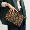 Model shown holding the Convertible Clutch in Toasty Cat.
