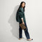 hover | Overlay:: Shown with The Shoulder Strap (sold separately) | Alt:: Alternate image of model shown holding the Convertible Clutch in Toasty Cat.