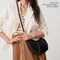 Model wearing The Crescent Bag in Black as a crossbody, shown with The Crossbody Strap. 