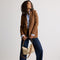 Alternative image of The Daily Crossbody in Macadamia Open-Knit, carried over the shoulder of a female model, shown from the right.
