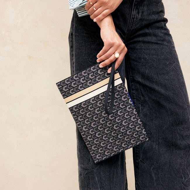 Model holding The Wristlet in Signature Black. 
