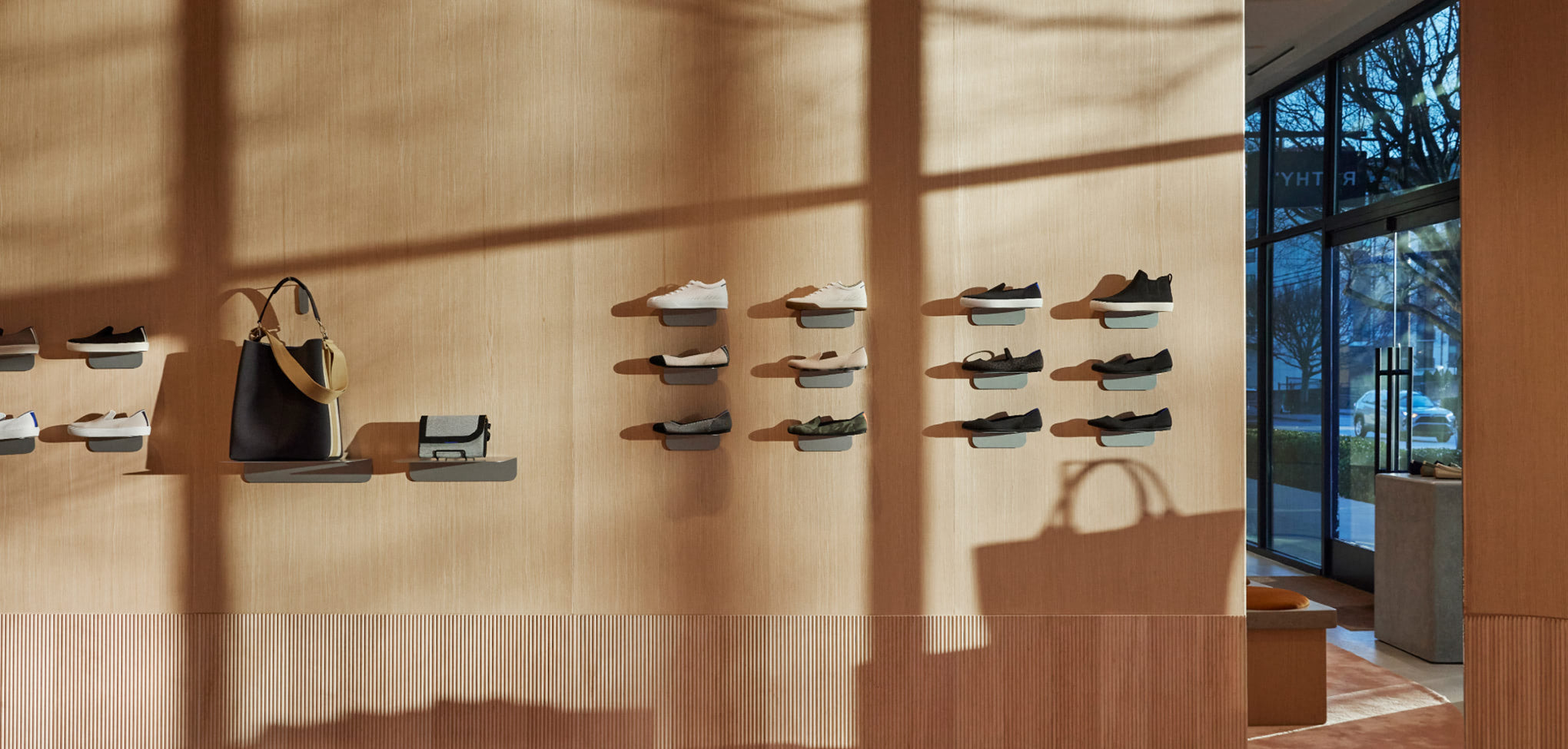 Rothy's interior store Wall display of handbags and shoes in a store setting