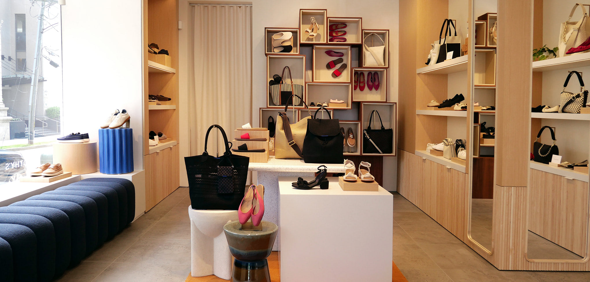 Rothy's interior store with shelves displaying handbags and shoes.
