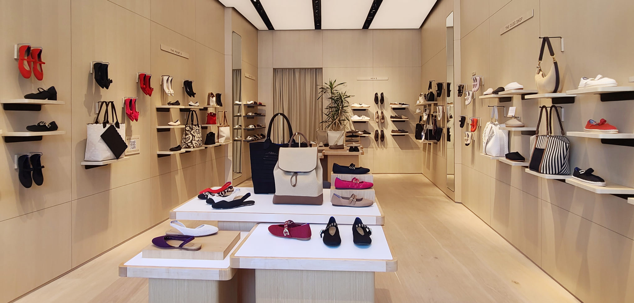 Rothy's interior store with various shoes displayed on shelves and tables.